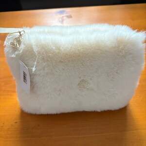 Sisley Paris Faux Fur Pouch with beauty products